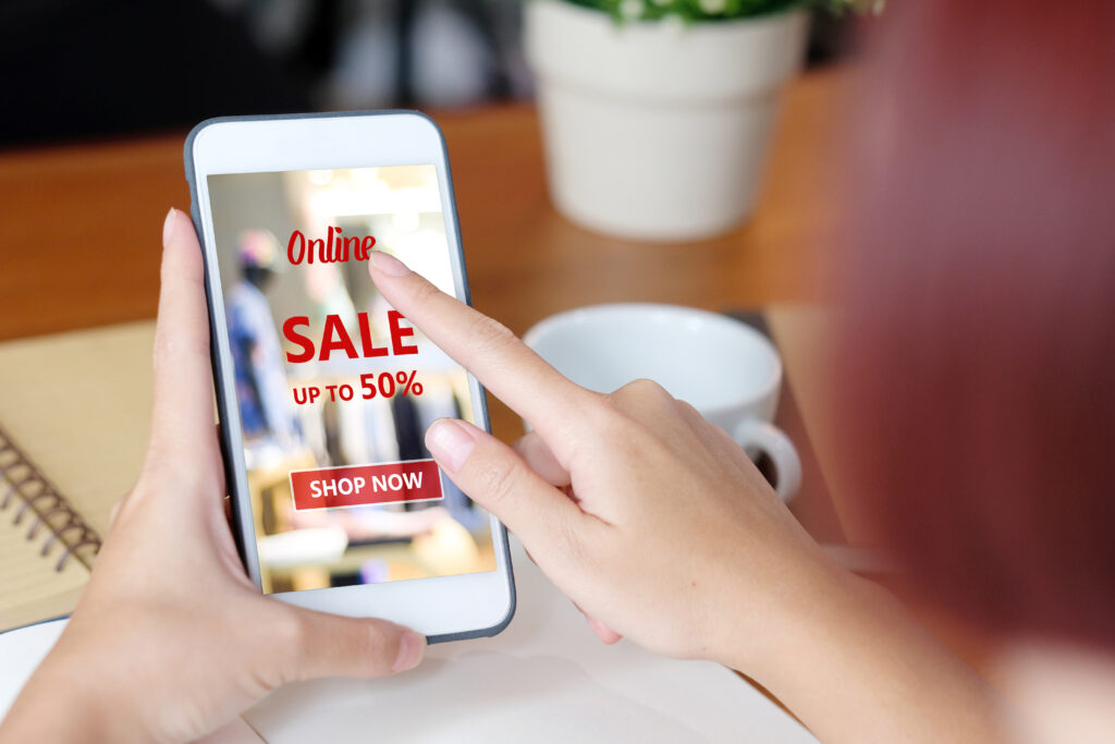 Image of Consumer looking at a sale on their cell phone